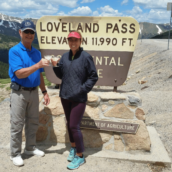 Colorado Executive Director Ken Oltjenbruns with Aprylle Gilbert (coast-to-coast run) having Champagne together at the summit of Loveland Pass