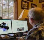 Guy R Cook at tje desk with duat montors