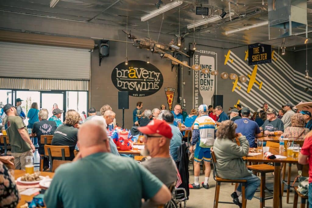 Craft beer enthusiasts enjoying Bravery Brewing's tasting room in Lancaster, California.